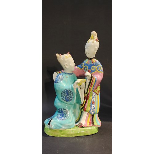 Group in Famille Rose porcelain representing a man offering a young woman a yellow enameled cup China period Qianlong 1736/1795